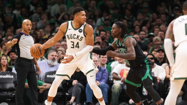 Milwaukee Bucks forward Giannis Antetokounmpo (34) defended by Boston Celtics guard Jrue Holiday (4) 
